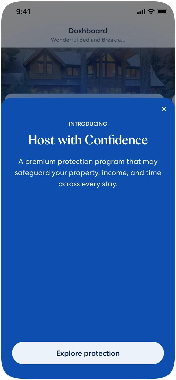 The Vrbo host dashboard on mobile with a sheet sliding up over it, introducing Host with Confidence as a premium protection program and offering an Explore protection button